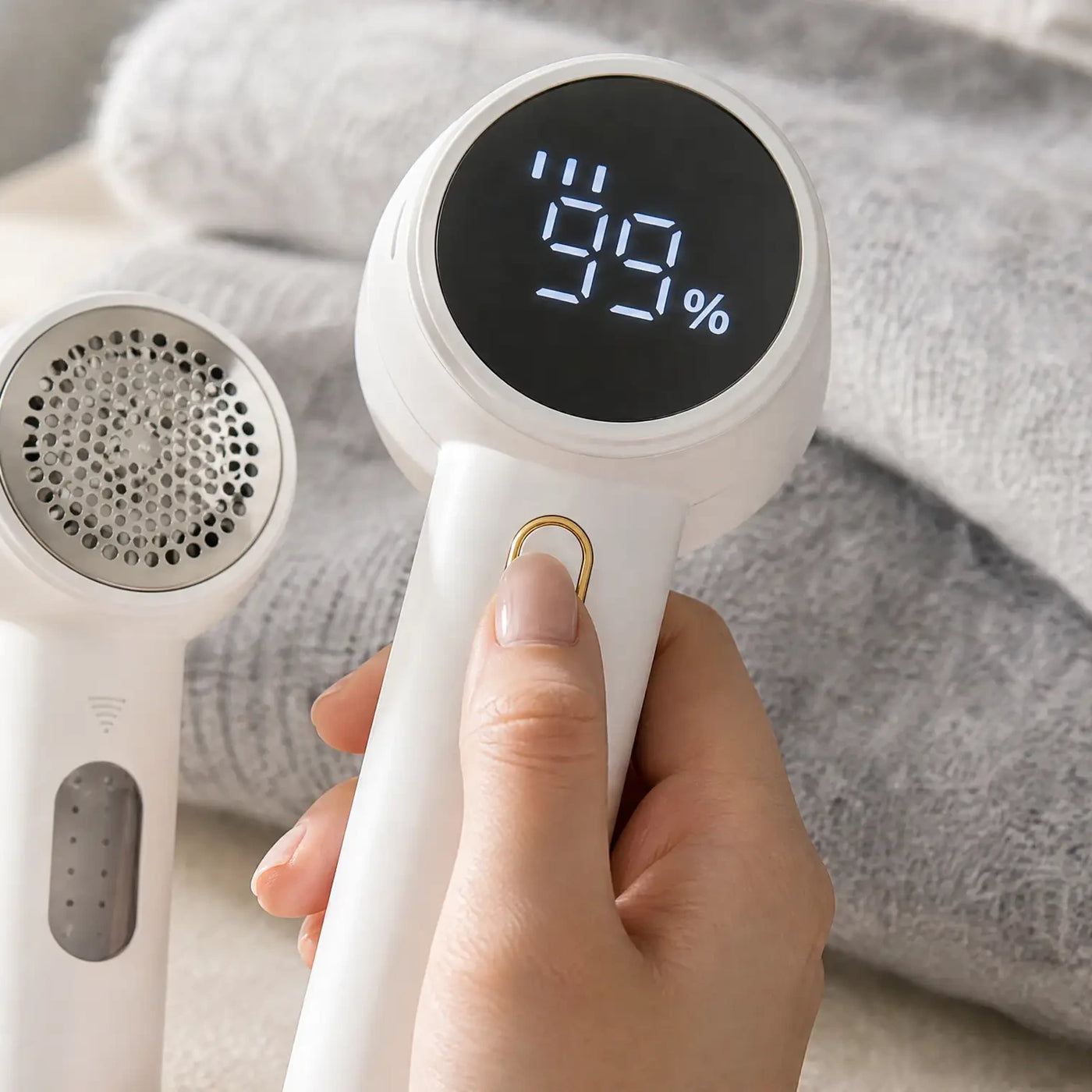 A thumb pressing the button while the display shows the level bars